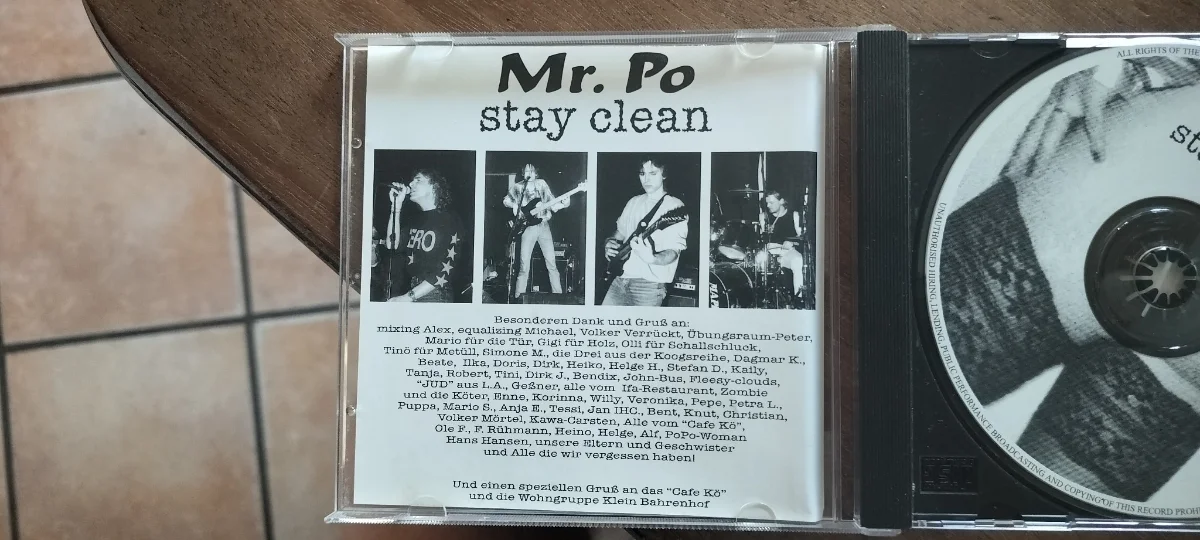 Mr. Po CD jewel case insert showing live photos of the four band members